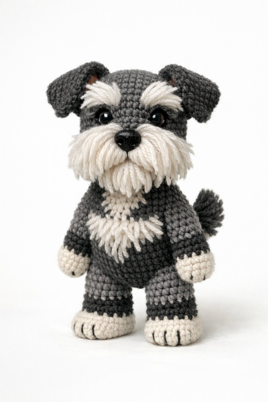 A crocheted schnauzer dog standing upright with detailed fur texture and characteristic facial features.