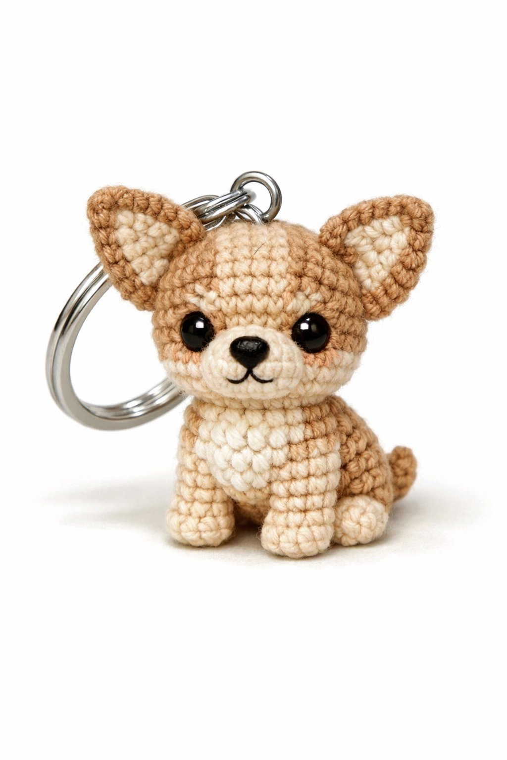 A small Chihuahua keychain made from crochet yarn with detailed stitching, attached to a silver ring.